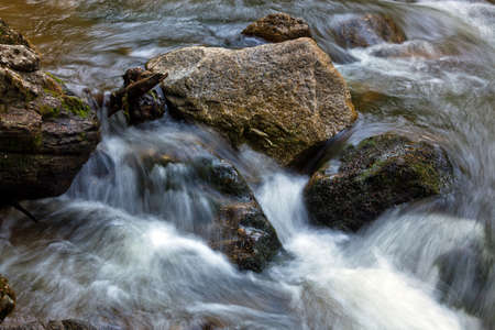 A cool stream of water and rocks in the mountains. Unspoiled nature.の写真素材
