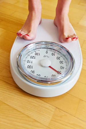 Turn the feet of a woman standing on bathroom scales toの写真素材