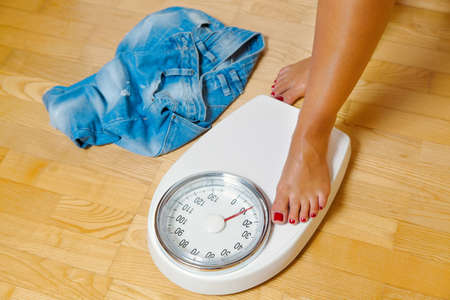 The feet of a woman standing on scales