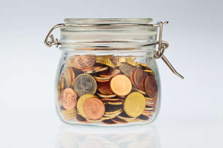 A jar of coins of the European currency Euro. Precautionary savings, and protection for the pension.