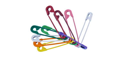 Lots of colorful safety pin lying on a white backgroundの写真素材
