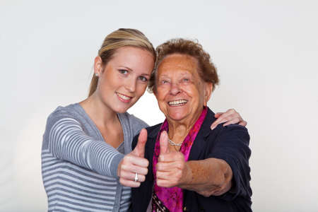a grandchild visiting his grandmother. laughter and joy. thumbs up