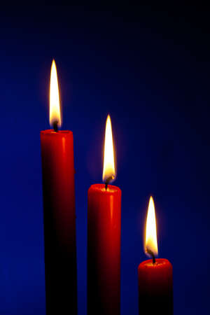 the flame of a candle brings light into darknessの写真素材