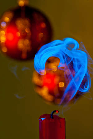 christmas is over. a kerza is blown out at the christmas tree.の写真素材