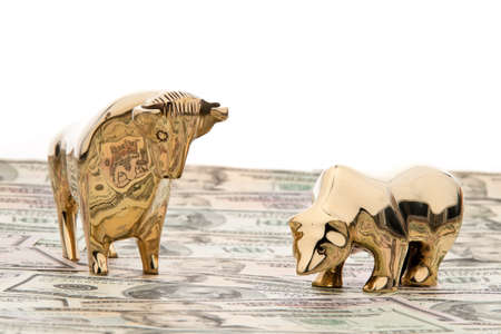 many dollar bills with bull and bear, symbol for stock exchangeの写真素材