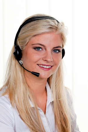 young woman with telephone headset in a call centerの写真素材