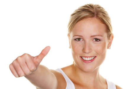 a young, successful woman holds his thumb up. symbol for success, exempted white backgroundの写真素材