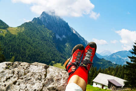red hiking boots for a hike in the mountains of austria. activity in leisure time