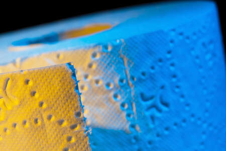 close up of a roll of toilet paper. toilet paper in colorful light.の写真素材