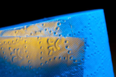 close up of a roll of toilet paper. toilet paper in colorful light.の写真素材