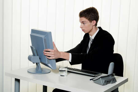 a man has problems with computer viruses and spam in the officeの写真素材