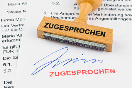 a stamp made of wood lying on a document. awarded inscriptionの写真素材