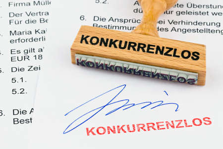 a stamp made of wood lying on a document. unrivalled inscriptionの写真素材