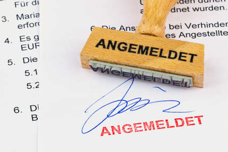 a stamp made of wood lying on a document. remember inscriptionの写真素材