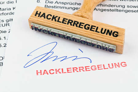 a stamp made of wood lying on a document. labeled heavy workersの写真素材