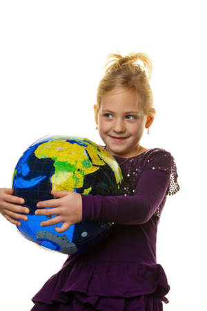 a little girl (child) looks at a globe.の写真素材