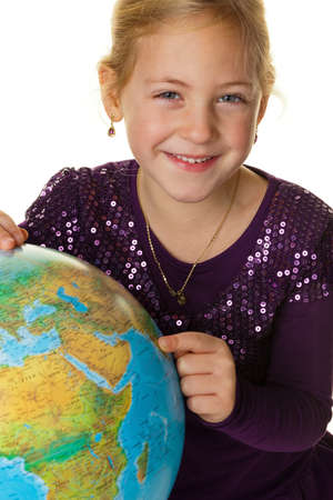 a little girl (child) looks at a globe.の写真素材