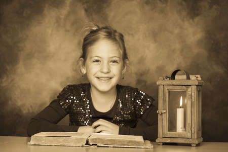 a child with a book and a lantern in the season of advent.の写真素材