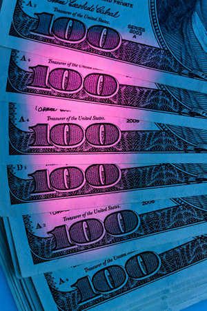detail of american dollar bills with colored lightの写真素材