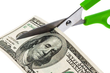 dollar currency notes and scissors. debt, budget, taxes and leviesの写真素材