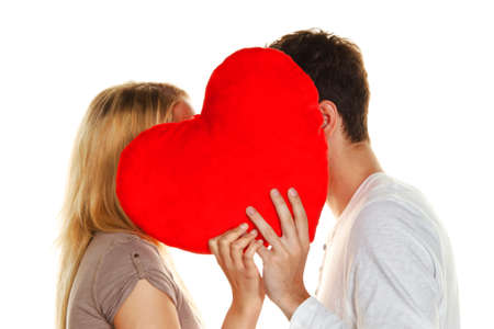 couple in love kissing behind a heart. love is beautiful. secret loveの写真素材