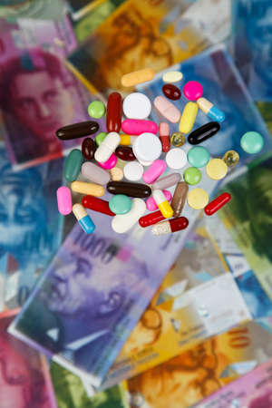 swiss franc and tablets as a symbol of health costsの写真素材