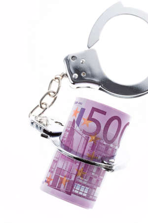 symbol of economic crime  handcuffs and â¬の写真素材