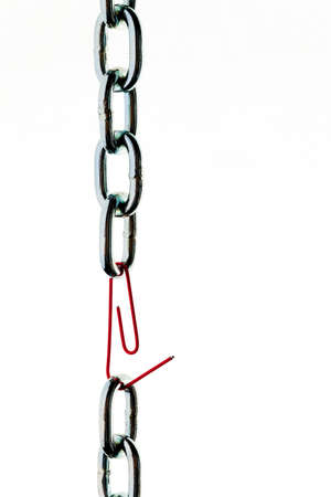 defective steel chain is held together by a paperclipの写真素材