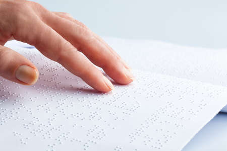 fingers and braille  blind people read a book in braille の写真素材