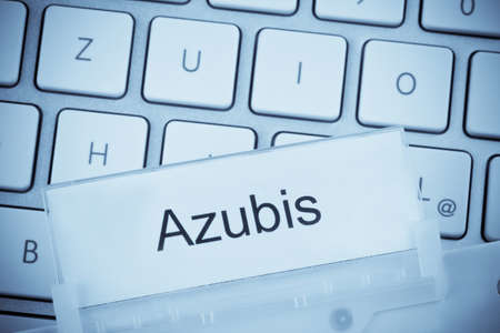 a folder for files in hanging folders in front of a computer keyboard on the topic  traineesの写真素材