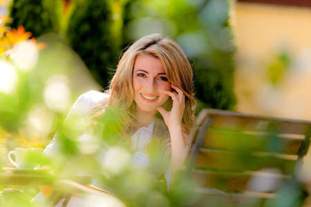 portrait of a cheerful young woman in the gardenの写真素材