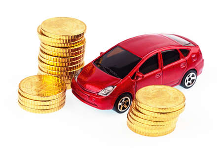 a model car and coins against white background, photo for price increases, fuel costs and car expenses の写真素材