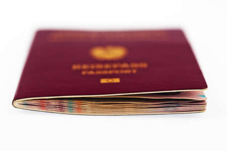 a red passport of the european union is on a white background の写真素材