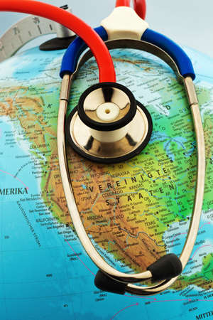 a stethoscope on a globe showing the americas の写真素材