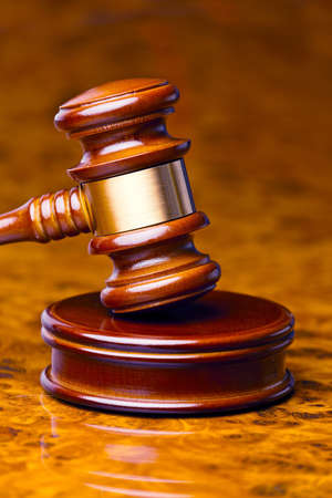 the gavel of a judge in court  lies on a desk の写真素材