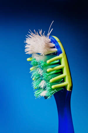 a damaged tooth brush waiting for the teeth cleaning  change toothbrushes more often の写真素材