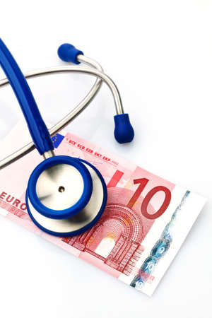 a stethoscope and a ten euro note  medical expenses and paymentの写真素材