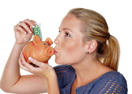 a young woman on a white background with a piggy bank  saving money as a pension の写真素材