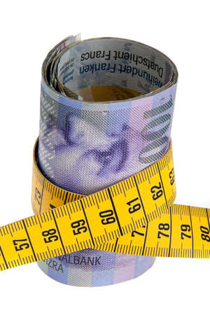 an icon image austerity package with swiss francs and tape measureの写真素材