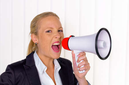 a young businesswoman with a megaphone makes an announcementの写真素材