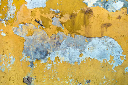 chipped yellow paint on a building  symbolic photo for moisture and damp walls の写真素材