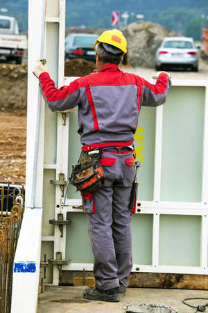 construction worker at a building formwork for concrete work  construction of an industrial building
