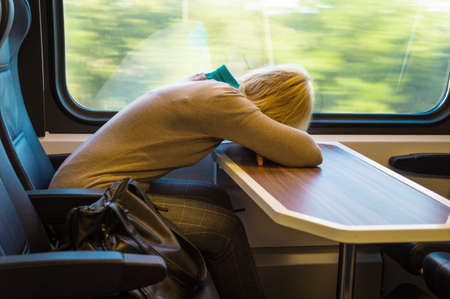 a sleeping woman on the train  travelling on a train relaxedの写真素材
