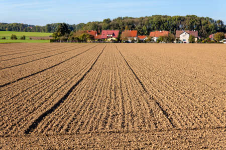 the freshly tilled fields of the farmers  background urbanization  spatial planning and regional planning の写真素材