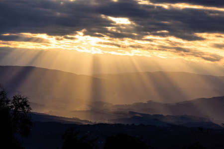 sun rays in cloudy sky in the eveningの写真素材