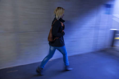 a young woman in an underpass for pedestriansの写真素材