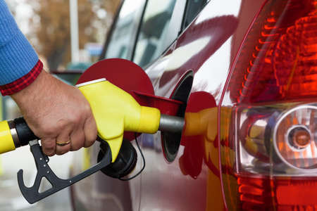 a young woman at a gas station gasoline tank 