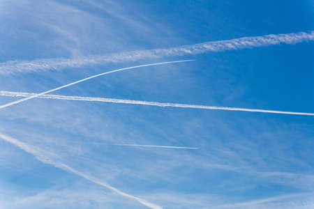 contrails of aircraft against a blue sky  routes in airwaysの写真素材