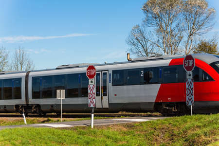 a crossing of a railway without barriers  secured only by traffic signs and whistles