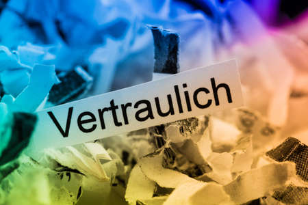 shredded paper tagged confidential, symbol photo for data destruction and confidentialityの写真素材